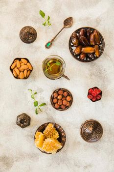 tea glass with dates fruit nuts table. High resolution photo