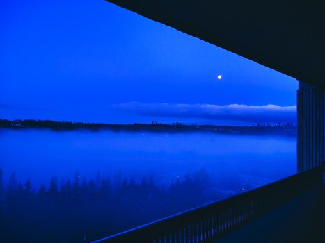 Night city with full moon overview from a patio