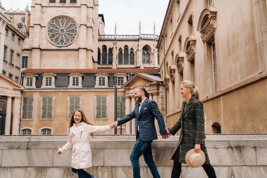 A beautiful family with strolls through the old city of Lyon in France.Family trip to the old cities of France.