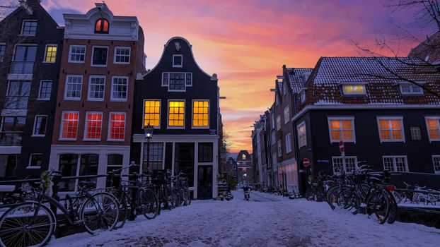 City scenic from snowy Amsterdam in the Netherlands at sunset