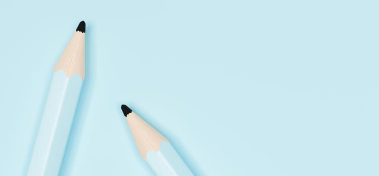 close-up banner of two pastel blue wooden pencils on blue background with text space. 3d rendering