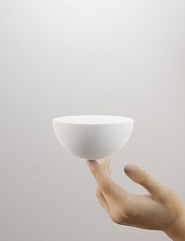 spherical product presentation stand held by a female hand on a white background. 3d rendering