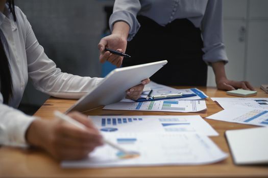 Fund managers teams researching and analysis Investment stock market by paperwork on wooden desk in office