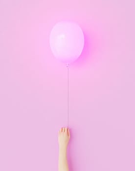 minimalistic scene with arm of person holding pink balloon on vertical pink background. 3d render