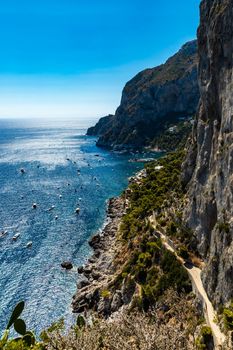 Beautiful view from cliff of small bay full of small ships and boats next to Capri island 