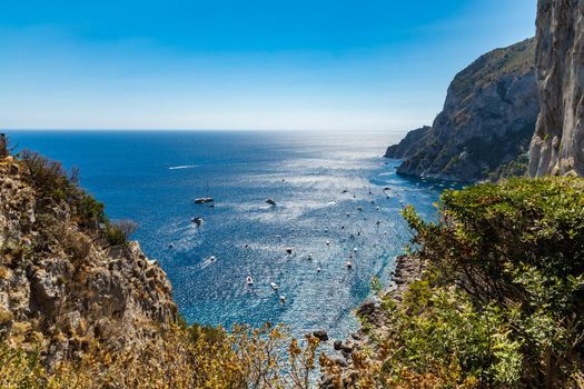 Beautiful panorama of small bay full of small ships and boats next to Capri island 