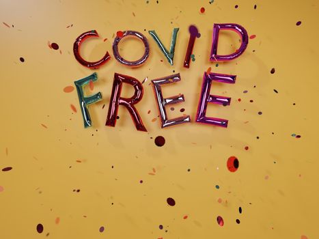 colorful balloon sign "Covid Free" with space for text and confetti falling on yellow wall. 3d render