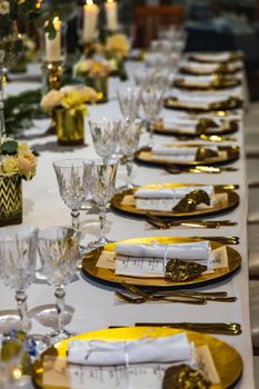 White green and golden decorations on wedding table at outdoor wedding