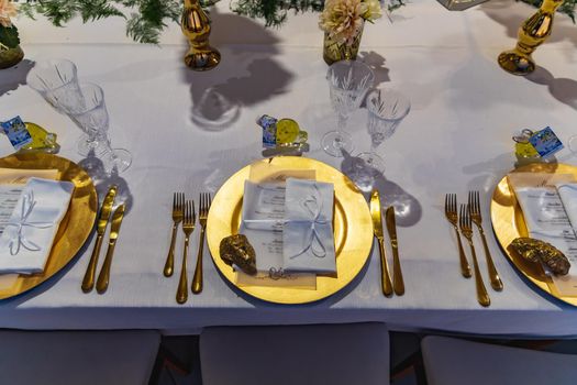 White green and golden decorations on wedding table at outdoor wedding