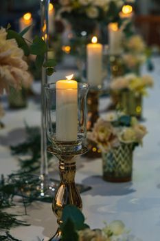 White green and golden decorations on wedding table at outdoor wedding