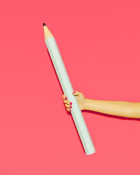 giant blue pencil held by a female hand with pink nails and pink background. 3d render