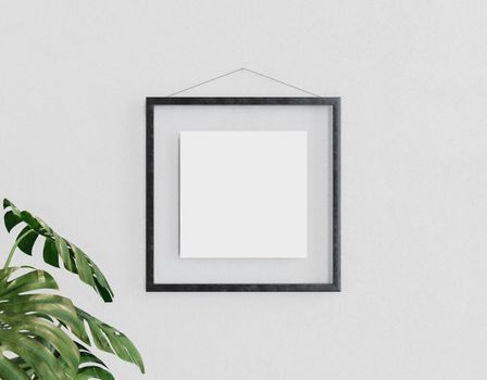 mockup of a square glass frame hanging on the wall with a plant next to it. 3d render