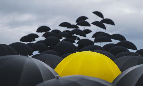 black umbrellas flying with a yellow umbrella standing out against the cloudy sky. winter concept, rain, wind and bad weather. 3d render