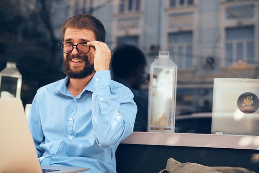 man in blue shirt laptop communication technology. High quality photo