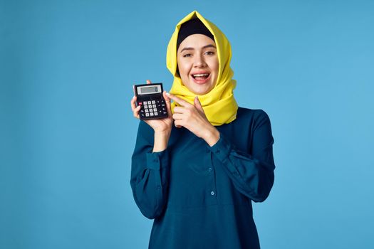 woman in yellow hijab technology calculator work finance. High quality photo