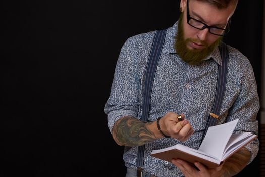 a business man in a shirt with a notebook in the hands of a manager. High quality photo