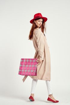 cheerful woman wearing a red hat posing shopping fun light background. High quality photo