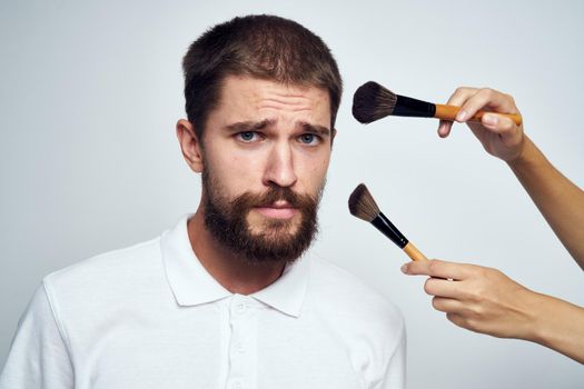 bearded man in white shirt cosmetics makeup. High quality photo