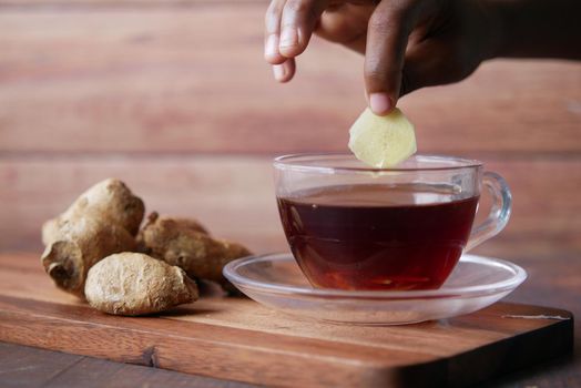 Top view of ginger tea on wooden background..