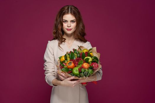 cheerful woman fun posing fruit bouquet vitamins isolated background. High quality photo