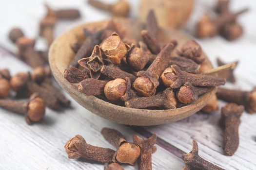 cloves on a spoon on table close up .