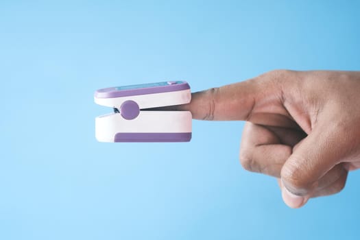 young man hand using pulse oximeter.