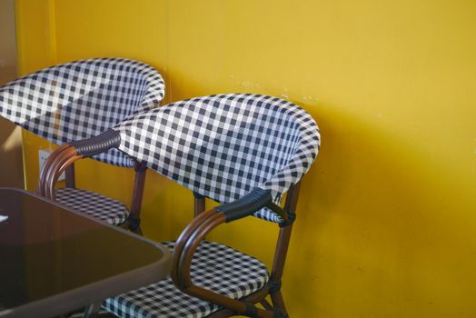 empty chair at cafe against yellow background ,