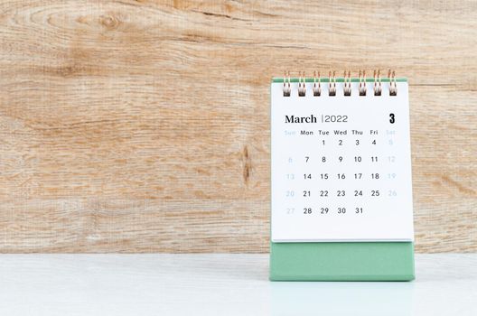 The March calendar 2022 on wooden background.