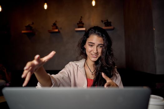 pretty woman in cafe in front of laptop working technology. High quality photo