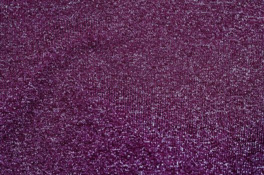 Dark violet fabric textured as background.