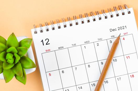 The December 2021 desk calendar with wooden pencil.