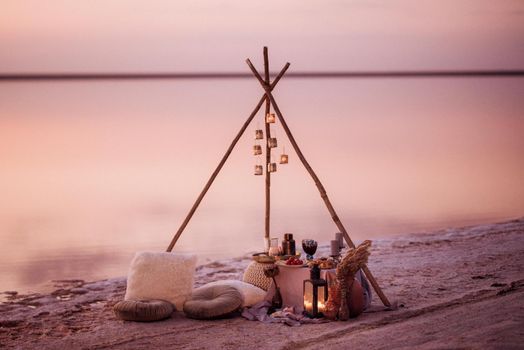 moroccan decor on the shores of a beautiful lake, candles and bungalows