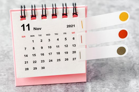 November 2021 desk calendar on the table.