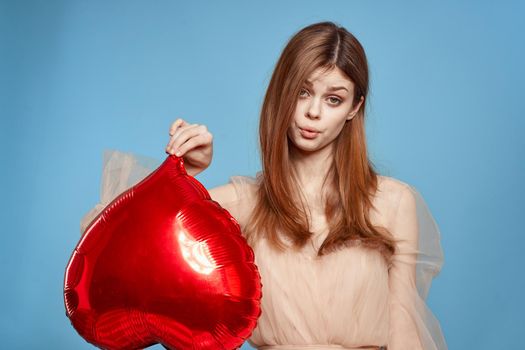 cheerful woman heart balloon holiday Valentine's Day blue background. High quality photo