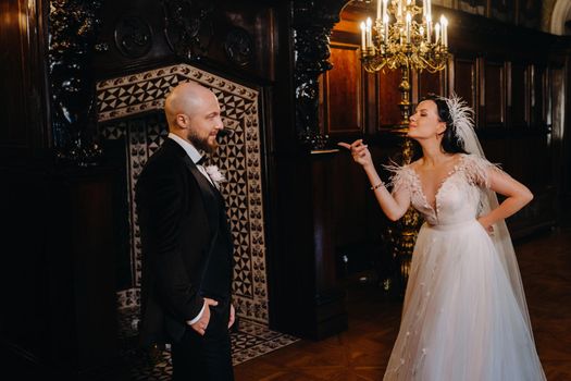 Elegant wedding couple in the interior of the old castle in the city of Nesvizh.