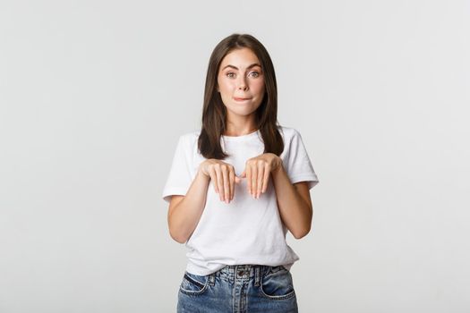 Silly and cute brunette girl smiling and standing in puppy pose.