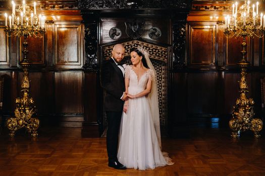 Elegant wedding couple in the interior of the old castle in the city of Nesvizh.