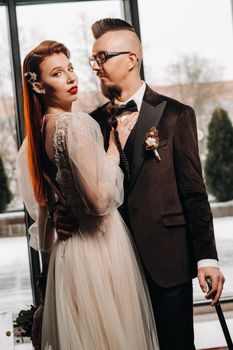 Stylish wedding couple in the interior. Glamorous bride and groom.