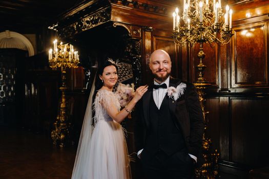 Elegant wedding couple in the interior of the old castle in the city of Nesvizh.