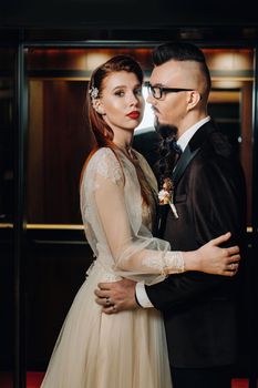 Stylish wedding couple in the interior. Glamorous bride and groom.