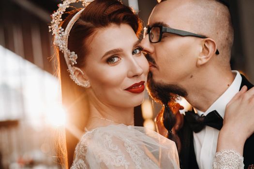 Stylish wedding couple in the interior. Glamorous bride and groom.