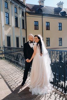 Elegant wedding couple on the balcony of an old castle in the city of Nesvizh.