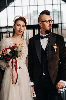 Stylish wedding couple in the interior. Glamorous bride and groom.