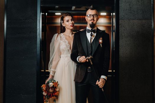 Stylish wedding couple in the interior. Glamorous bride and groom.