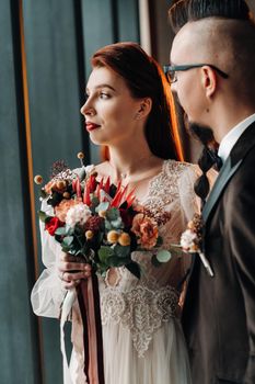 Stylish wedding couple in the interior. Glamorous bride and groom.