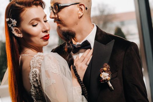 Stylish wedding couple in the interior. Glamorous bride and groom.