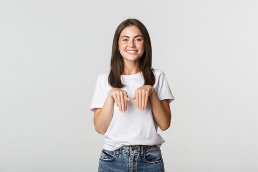 Silly and cute brunette girl smiling and standing in puppy pose.