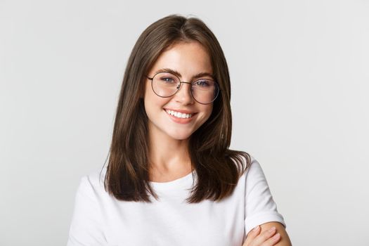 Close-up of smiling confident, beautiful brunette girl in glasses looking happy.