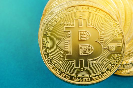 Bitcoin Digital currency. Cryptocurrency. Golden coin with bitcoin symbol on blue background.