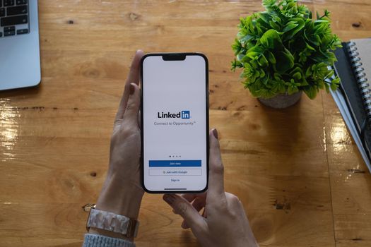 CHIANG MAI, THAILAND: OCT 18, 2021: LinkedIn logo on phone screen. LinkedIn is a social network for search and establishment of business contacts. It is founded in 2002